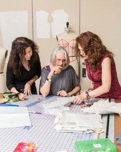 3 women working on a textile design
